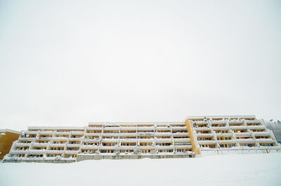 Low angle view of building against snow covered sky