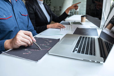 Midsection of business person working in office