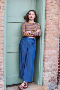 Portrait of woman standing against wall