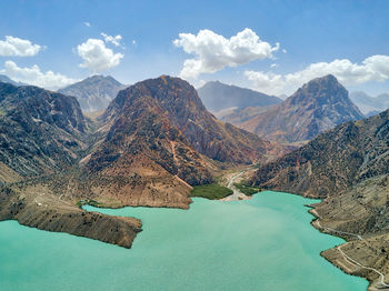 High angle view of lake amidst mountains against sky