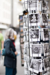 Reflection of man photographing in store for sale