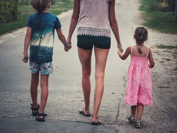 Rear view of women walking outdoors