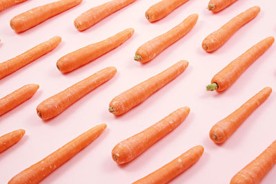 High angle view of carrots arranged on white background