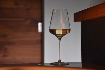 Close-up of white wine in wineglass on table