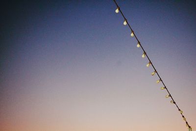 Low angle view of cables against clear blue sky