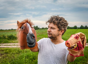 Senior man standing in a field