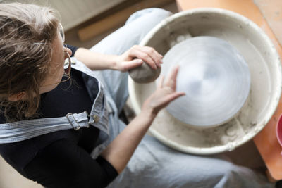 Woman using potters wheel