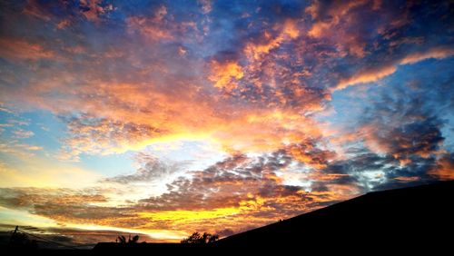 Low angle view of dramatic sky during sunset