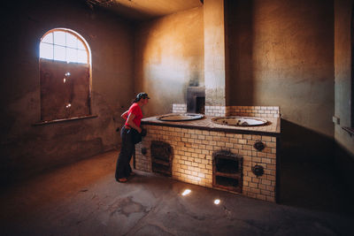 Side view of man standing in building