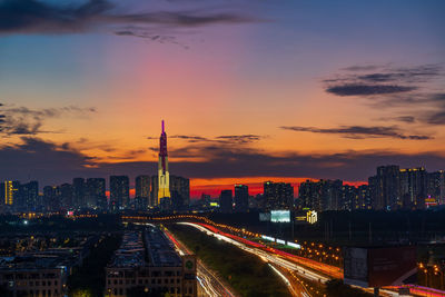 High angle view of illuminated buildings against sky during sunset