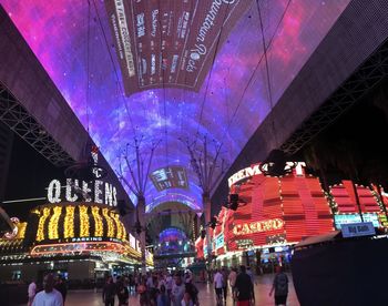 Group of people in front of illuminated building at night