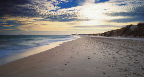 Scenic view of beach against sky during sunset