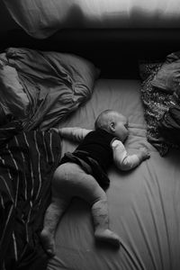 High angle view of baby sleeping on bed at home