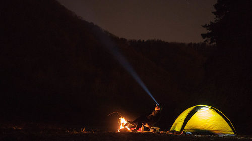 Firework display against sky at night