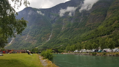 Scenic view of lake and mountains against sky