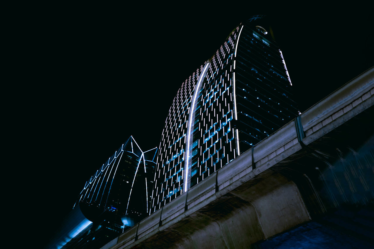 LOW ANGLE VIEW OF ILLUMINATED BRIDGE AGAINST CLEAR SKY AT NIGHT