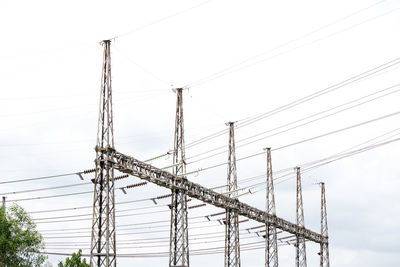 Low angle view of electricity pylon against clear sky