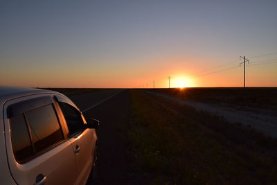 Road against clear sky during sunset