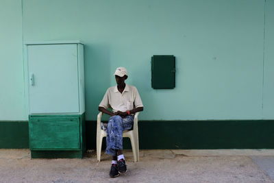 Full length of man standing against door