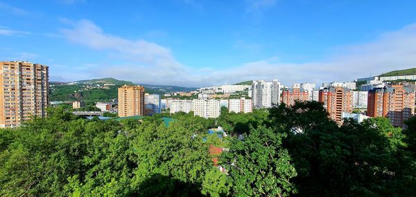 View of cityscape against blue sky