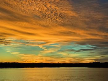 Scenic view of lake against orange sky