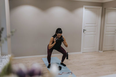 View of woman exercising at home