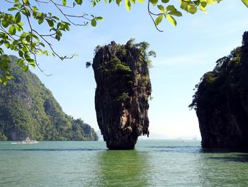 Scenic view of rock formation in sea against sky