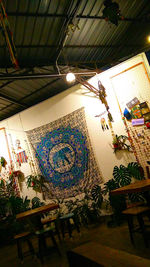Low angle view of illuminated lighting equipment hanging on ceiling