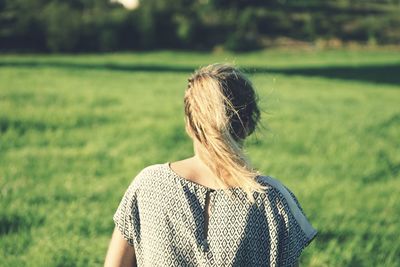 Rear view of woman on field