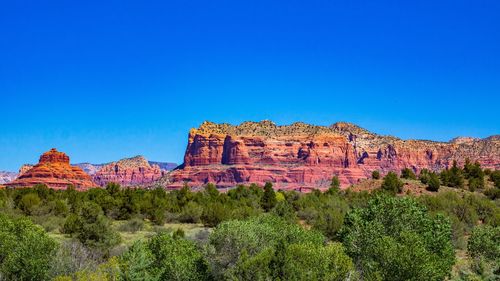 View of rock formations against blue sky