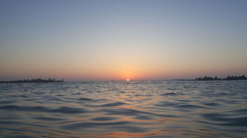 Scenic view of sea against clear sky during sunset