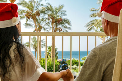 Rear view of woman looking at sea against sky