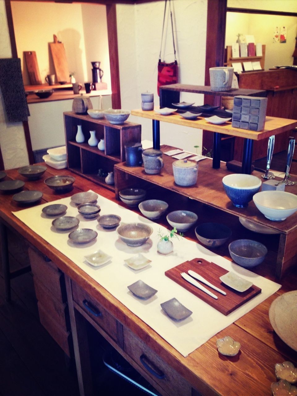 indoors, table, food and drink, still life, large group of objects, arrangement, restaurant, chair, drink, plate, variation, absence, dining table, no people, order, abundance, shelf, place setting, desk, empty