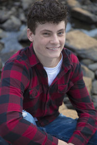 Portrait of smiling man sitting outdoors