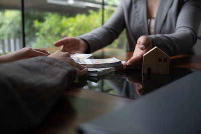 Midsection of man using mobile phone