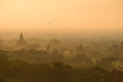 Aerial view of a temple by building against sky