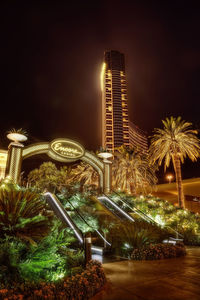 Illuminated modern building against sky at night