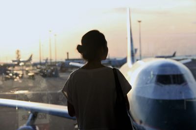 Rear view of woman standing against sky