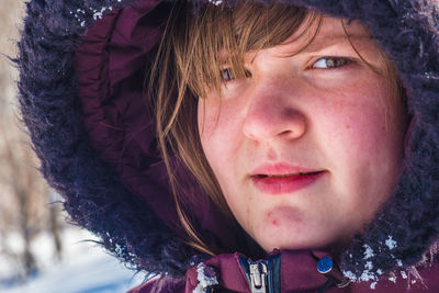 Close-up portrait of woman in hat during winter