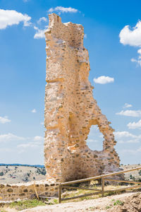 Low angle view of old ruins against blue sky