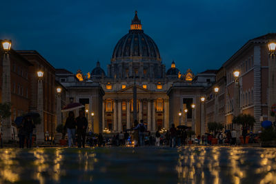 Group of people in illuminated building at night