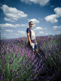 Full length of woman standing on field against sky