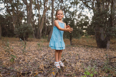 Portrait of smiling girl standing on land