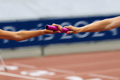 Midsection of woman exercising on court