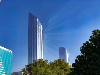 Low angle view of modern buildings against clear blue sky