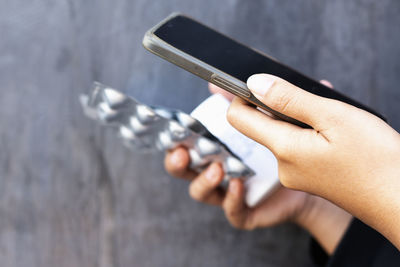 Cropped hands of man using mobile phone