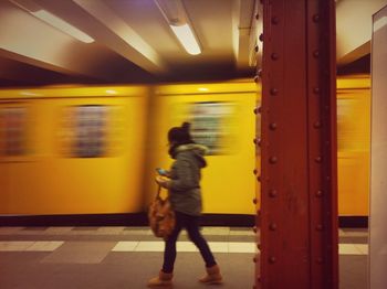 Blurred motion of man walking on sidewalk