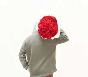 Person with red rose against white background