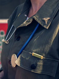 Midsection of female soldier with stethoscope