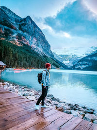 Full length of man standing by lake against sky